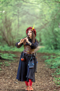 Full length of young woman standing on field