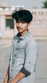 Portrait of young man standing outdoors