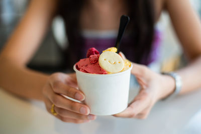 Midsection of woman holding ice cream