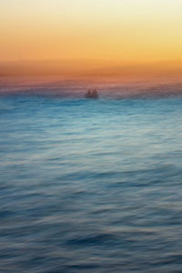 Scenic view of sea against sky at sunset