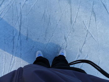 Low section of man standing on tiled floor