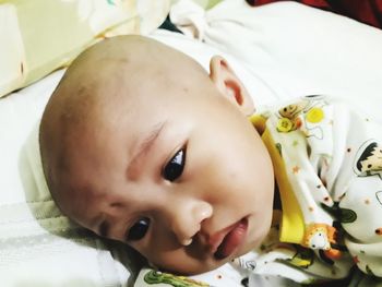 Close-up portrait of cute baby lying