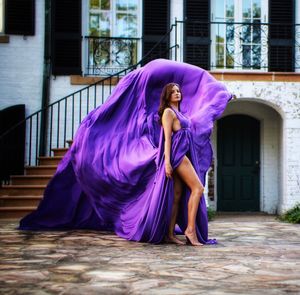 Woman with umbrella standing against building in city