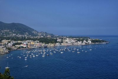 Scenic view of sea by buildings against sky