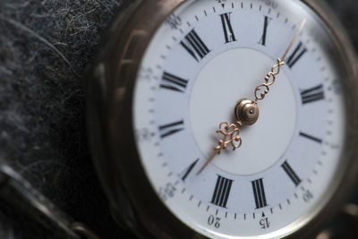 Close-up of pocket watch on table
