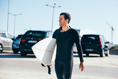 Portrait of surfer in carpark