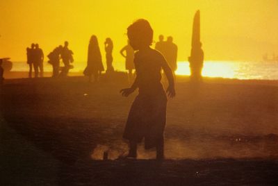 Two people playing at sunset