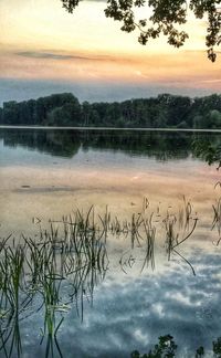Scenic view of lake against sky at sunset