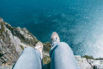 Low section of person sitting on beach