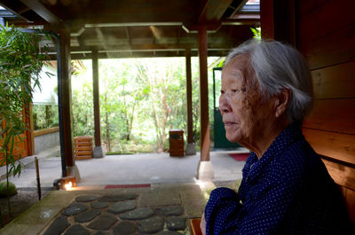 Side view of thoughtful senior woman sitting in patio