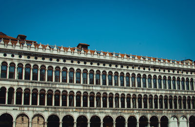 Low angle view of historical building against blue sky