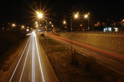 Night traffic light trails created by red rear and white headlights of mowing vehicles  