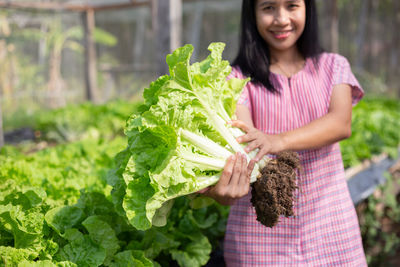Young woman smiling while standing outdoors