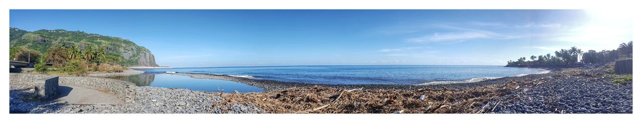 Panoramic view of sea against blue sky