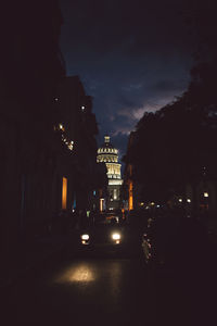 Illuminated city street and buildings at night