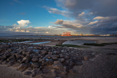 View of beach against cloudy sky