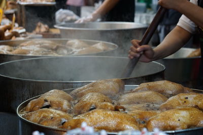 Midsection of person preparing food in kitchen