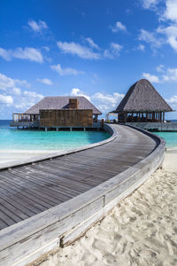 Built structure on beach against blue sky