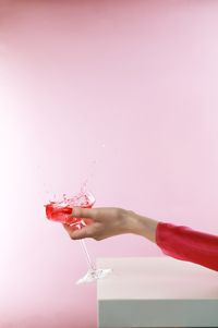 Cropped hand of woman holding flower