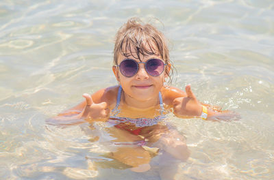 Portrait of woman swimming in sea