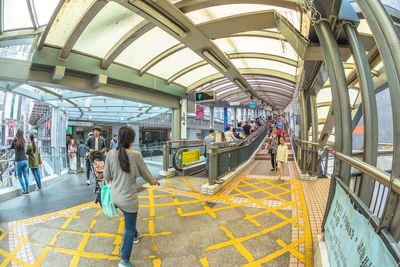 People walking on train in city