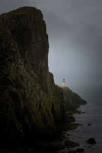 Rock formations by sea against sky