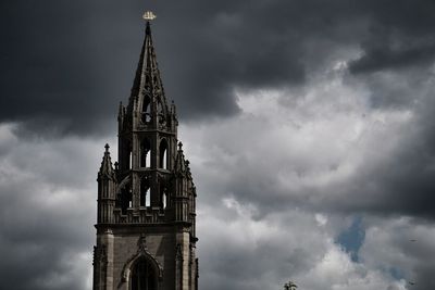 Low angle view of building against cloudy sky