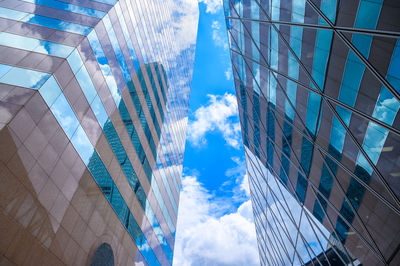 Low angle view of modern buildings in city against sky