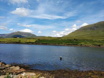 Scenic view of lake and mountains against sky