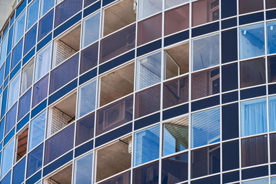 Low angle view of modern glass building in city