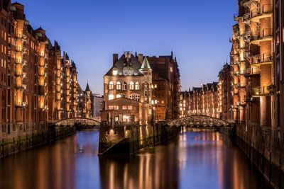 Reflection of illuminated buildings in water at night