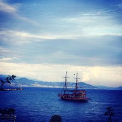 Sailboat in sea against sky