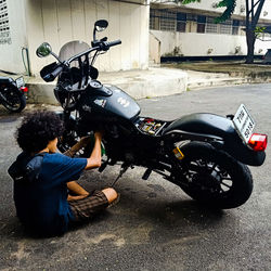 Man riding motor scooter on city