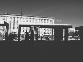 Silhouette people in front of building