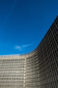 Low angle view of modern building against blue sky