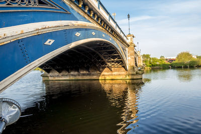 Arch bridge over river against sky