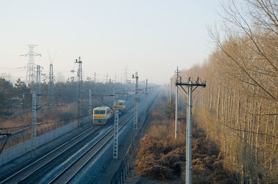High angle view of railroad tracks against clear sky during winter