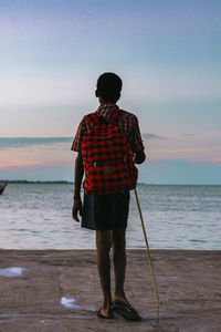 Rear view of man standing on beach