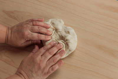 High angle view of woman hand on hardwood floor