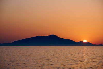 Scenic view of sea against romantic sky at sunset