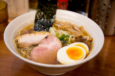 High angle view of soup served in bowl on wooden table