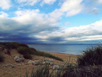 View of beach against cloudy sky