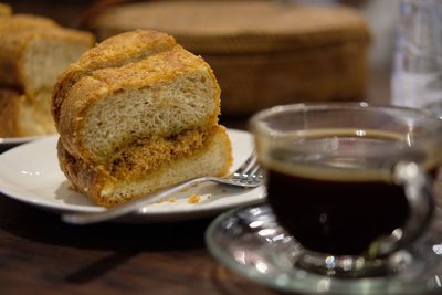 Close-up of bread and black coffee on table