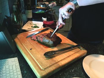 Close-up of man preparing food on cutting board