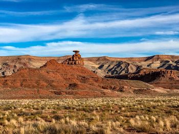 Rock formations on landscape against sky