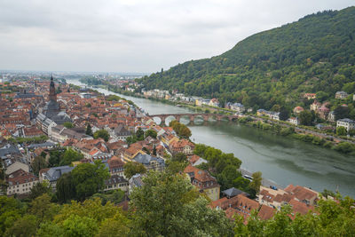 High angle view of townscape by river against sky