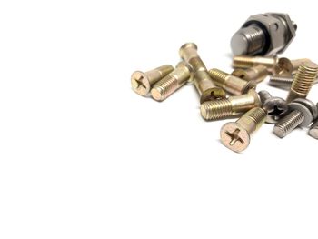 High angle view of nuts and bolts on white background