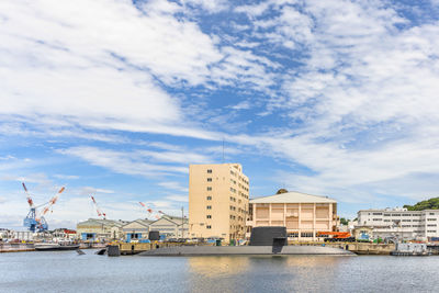 Pier by sea against sky in city