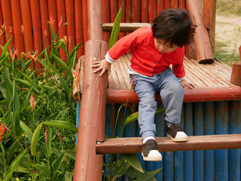 Close-up of girl sitting on play equipment