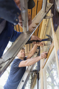 Men repairing window